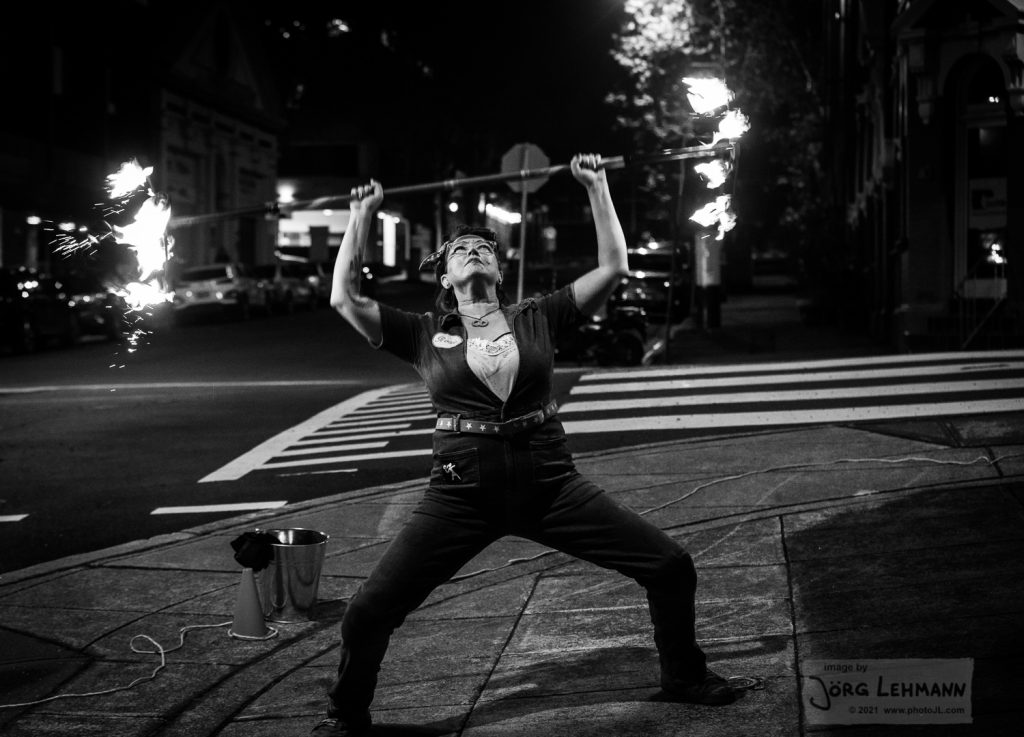Rosie the riveter costume is a denim boiler suit- this image is in black and white shes pretending to dead lift the staff like a weightlifter.
photos by jorg lehmann