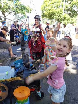 kids with happy faces engoying a bubble show - maitland train station steamfest