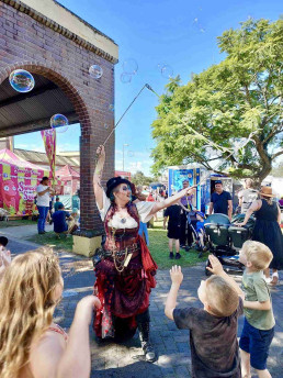 kids with big bubbles jumping - maitland steamfest